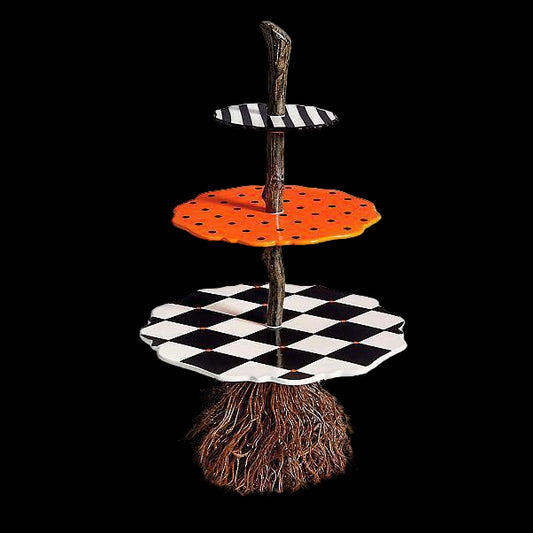 Three-tiered decorative stand with checkered, polka dot, and orange patterns on a white background.