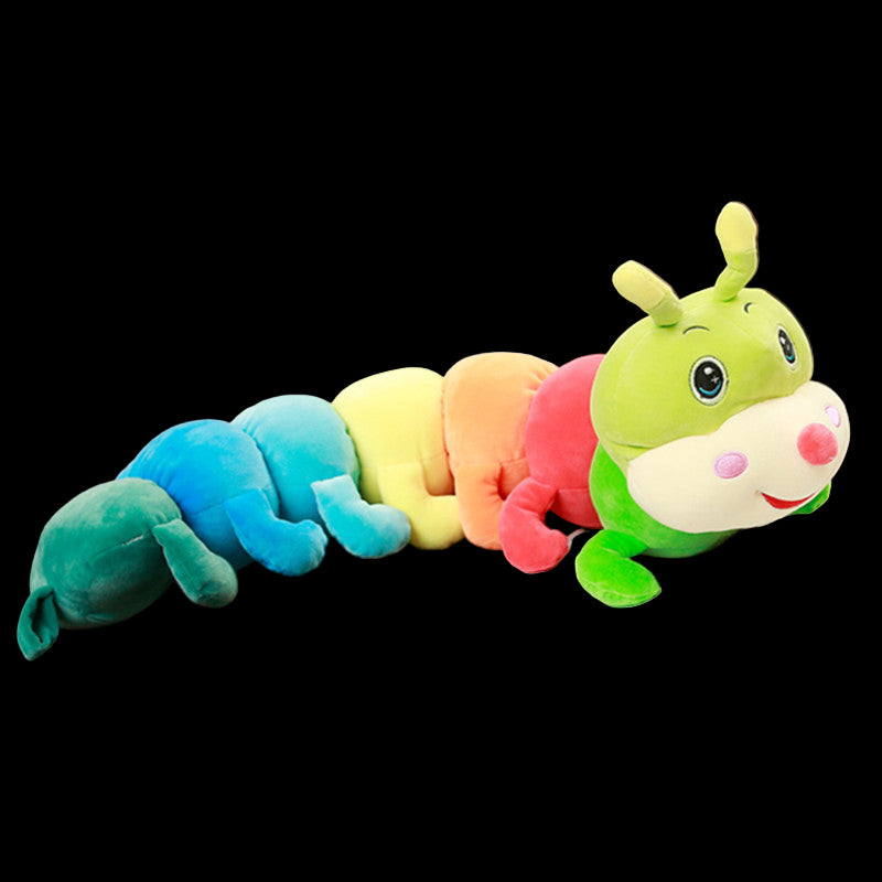 Colorful caterpillar plush toy on an open book in a restaurant setting