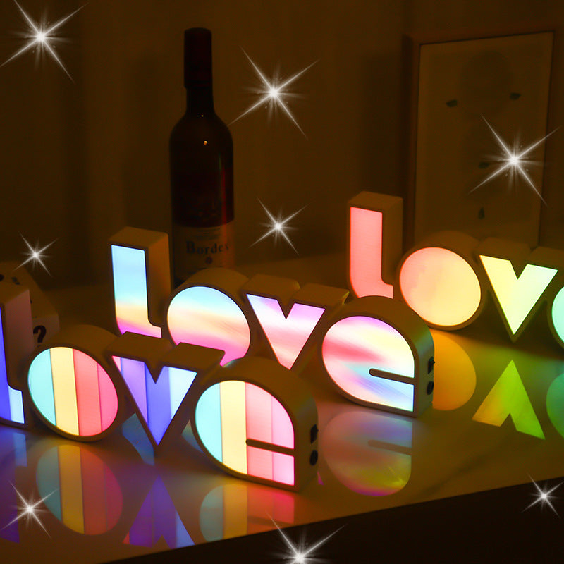 Colorful 'LOVE' letters with a bottle in the background