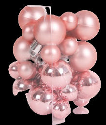 Clear box with pink and silver Christmas balls on a white background