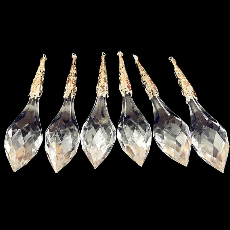 Set of six clear crystal teardrop pendants on a black background