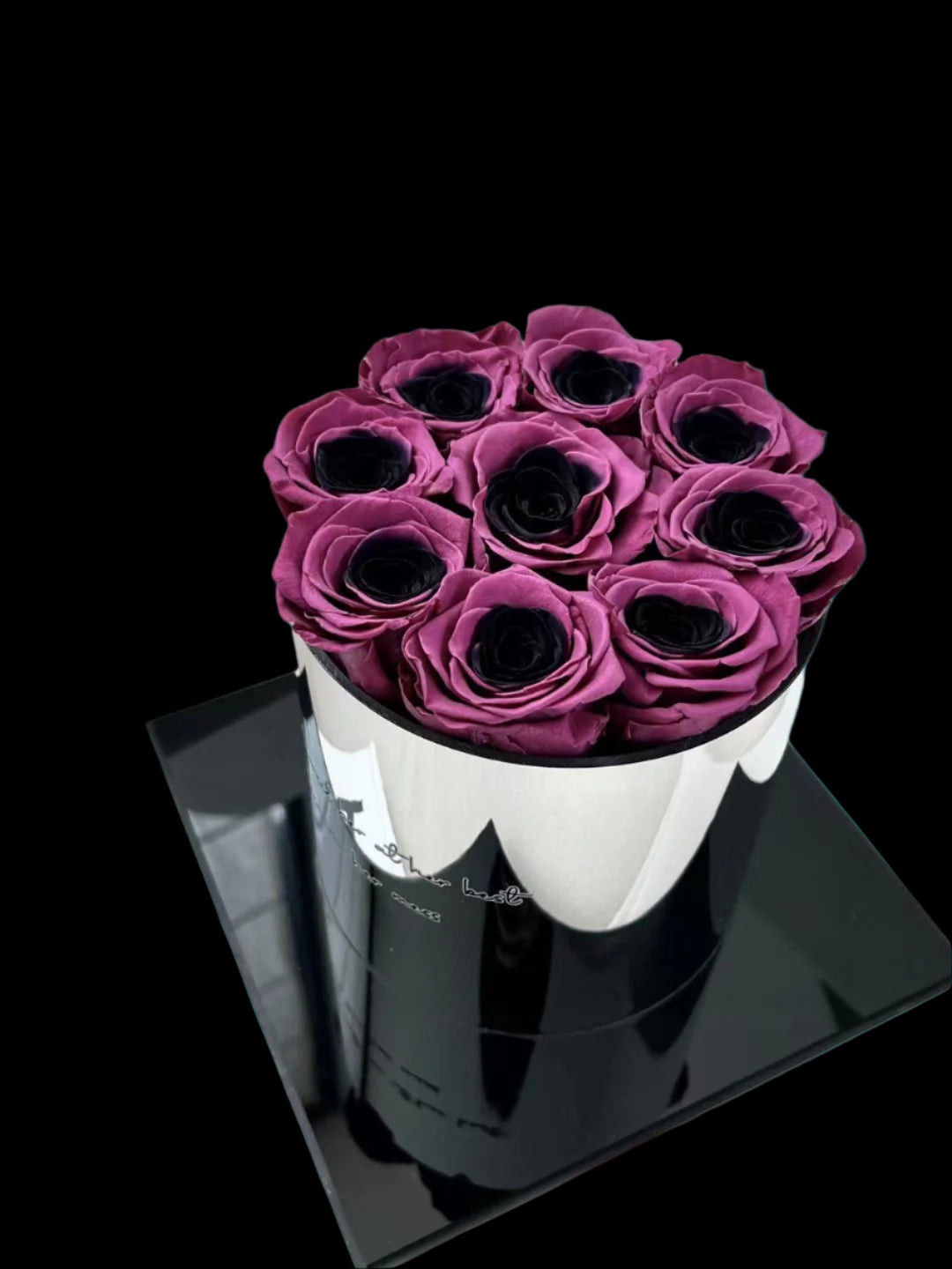 White cylindrical container with purple roses on a light gray surface