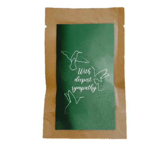 Green card with white dove design and text on a wooden surface