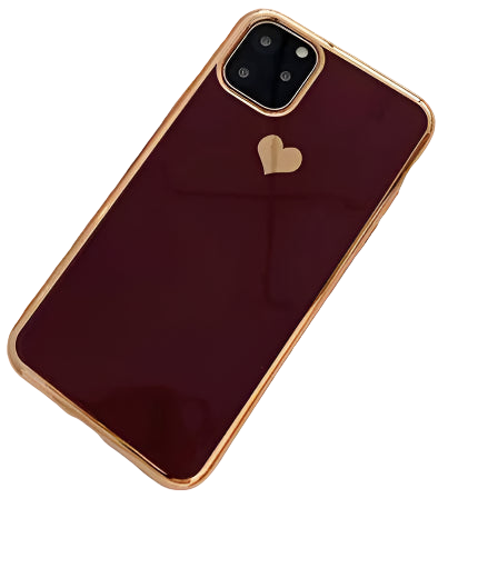 Phone case with heart design on a surface with a notebook and glass of water.