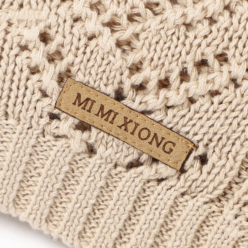 Close-up of a beige knitted fabric with a 'MI MI XIONG' label.