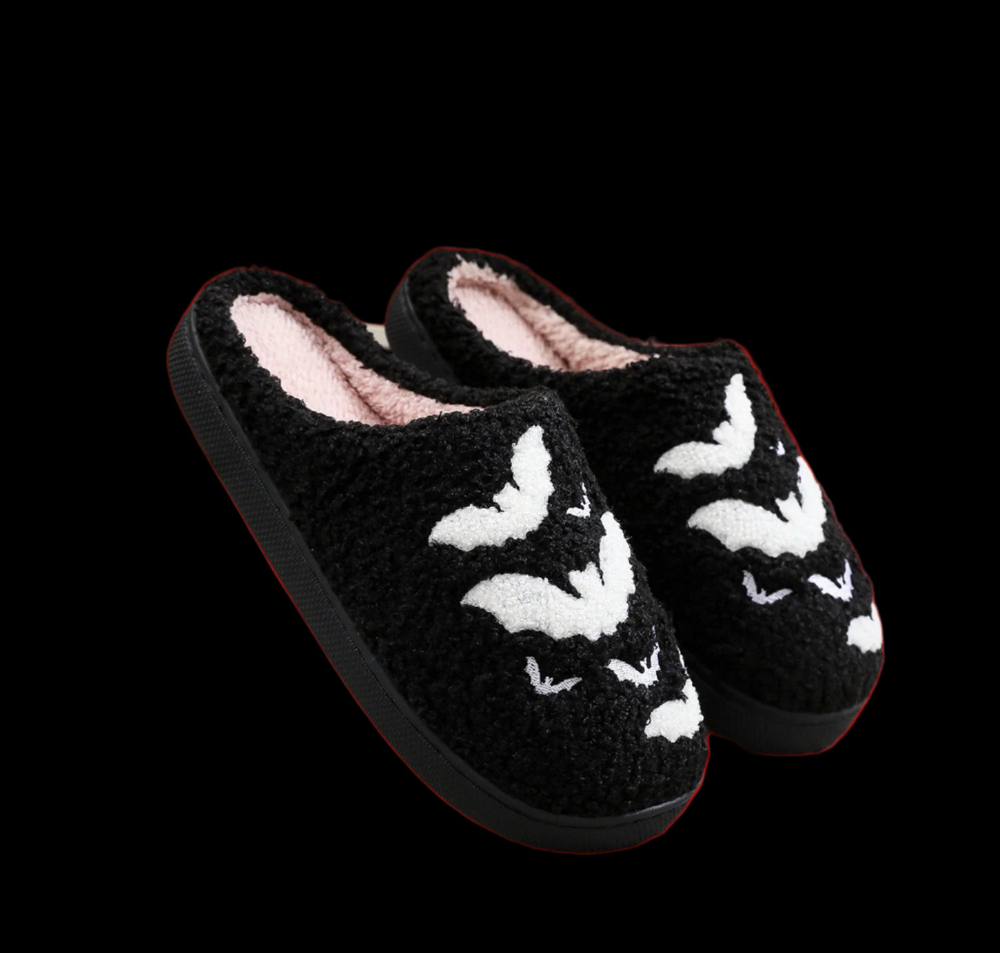 Black slippers with white fox designs on a textured surface.