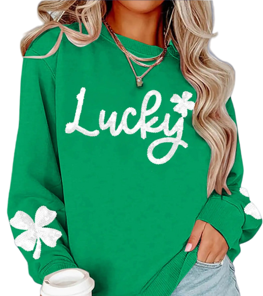 Green sweatshirt with 'Lucky' and clover design, worn by a person holding a Starbucks cup.