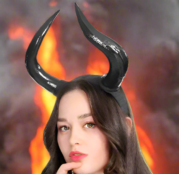 Woman wearing black devil horns on a white background