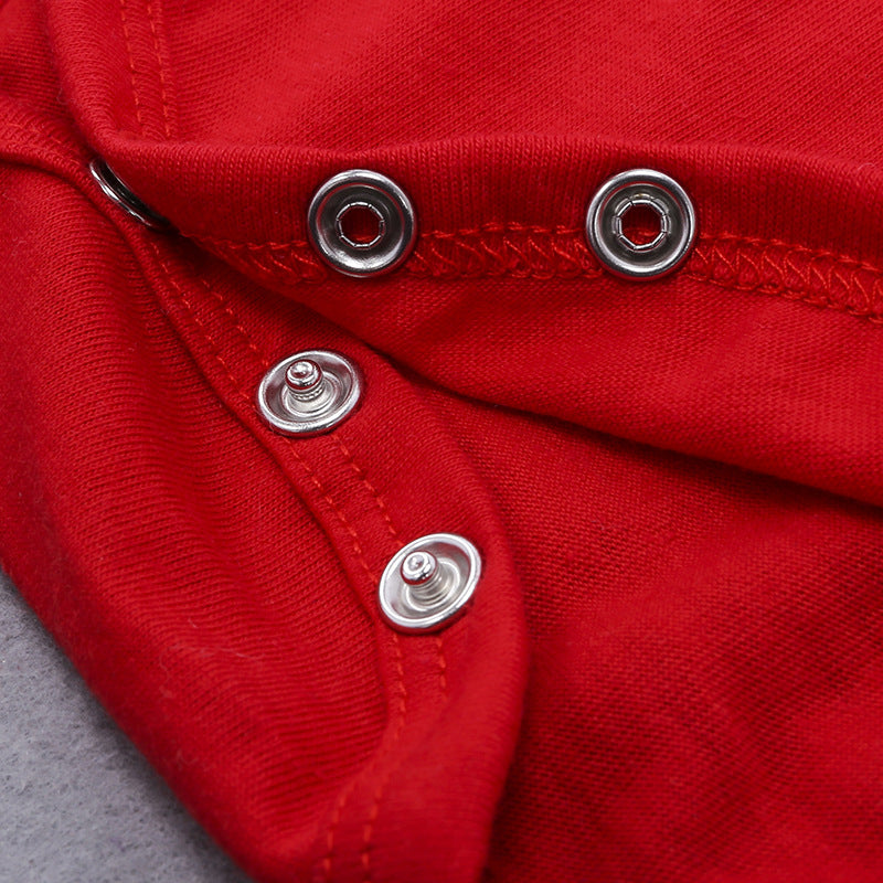 Close-up of red fabric with metal buttons on a gray background