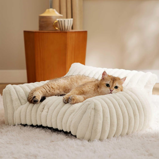 Cat lying on a fluffy white pet bed in a cozy room.