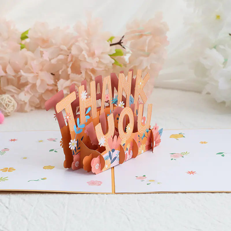 3D pop-up card with 'THANK YOU' text and floral decorations on a floral background