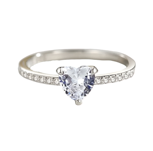 Silver ring with a heart-shaped gemstone on a light background