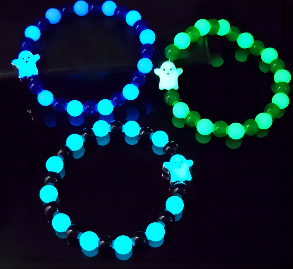 Two glow-in-the-dark bracelets, one blue and one green, on a black background with text about light absorption.