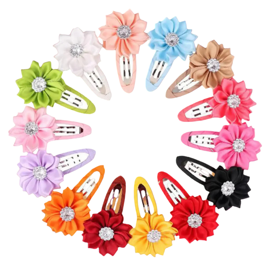 Set of colorful flower-shaped hair clips with rhinestones on a white background