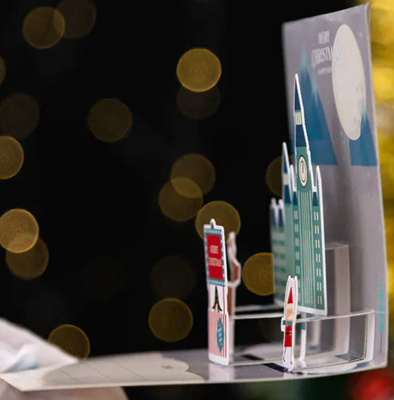 Model of a city street with buildings and people against a blurred bokeh background