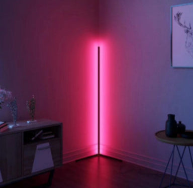 Modern floor lamp emitting a red glow in a room with minimal decor.