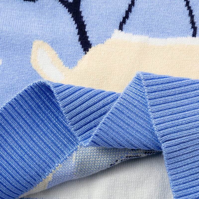 Close-up of a blue fabric with a pattern, featuring a beige animal figure.