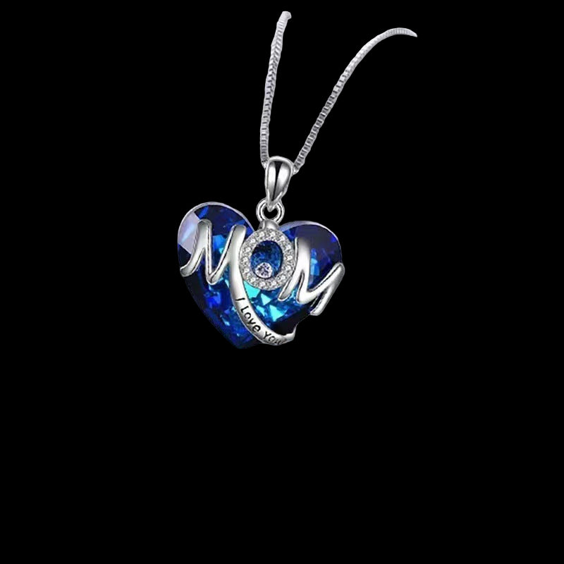 Heart-shaped necklace with blue and silver design on a white surface