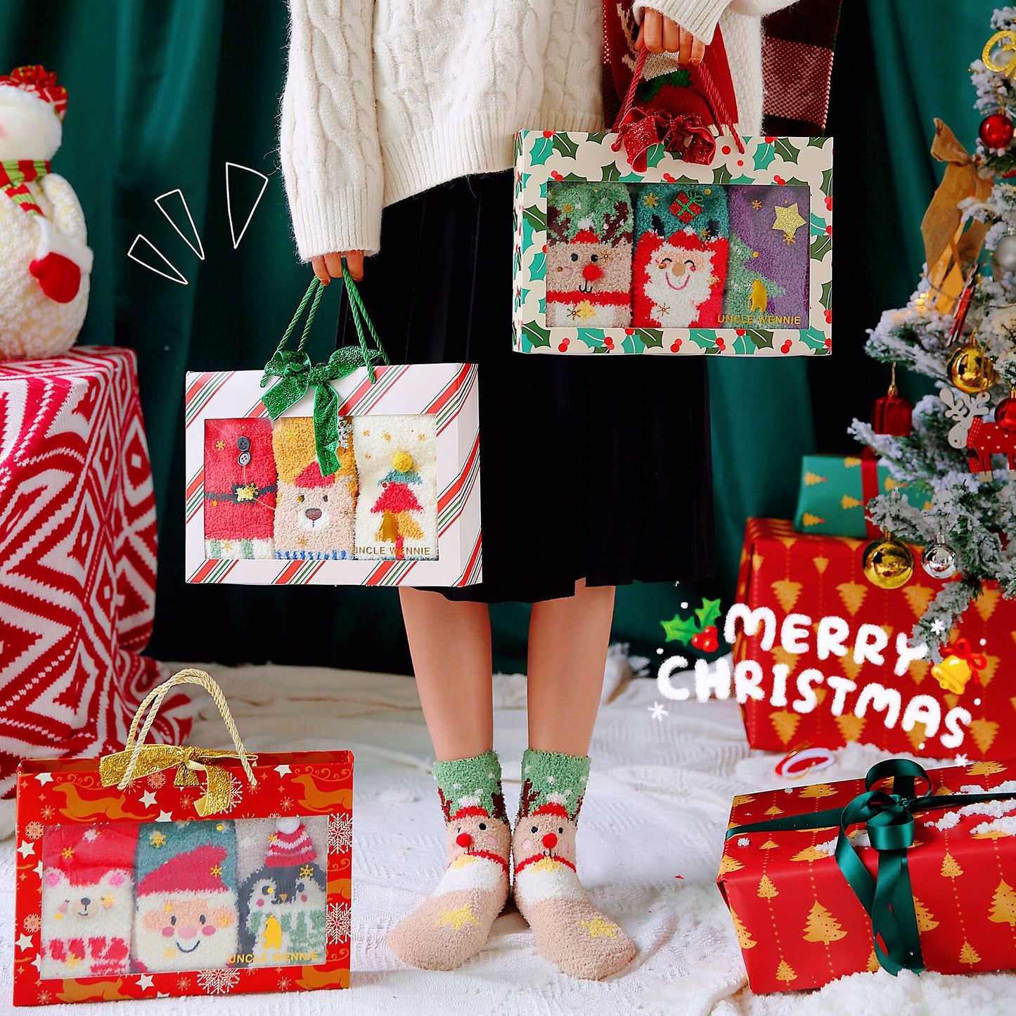 Person holding Christmas-themed gift bags with a decorated tree and presents in the background.