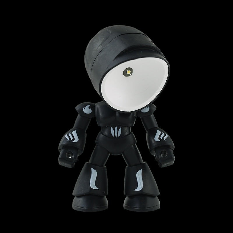Black robot toy with a white face on a gray background