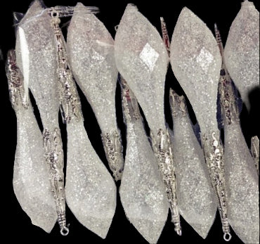 Set of glittery silver spoons in a clear plastic bag on a black background