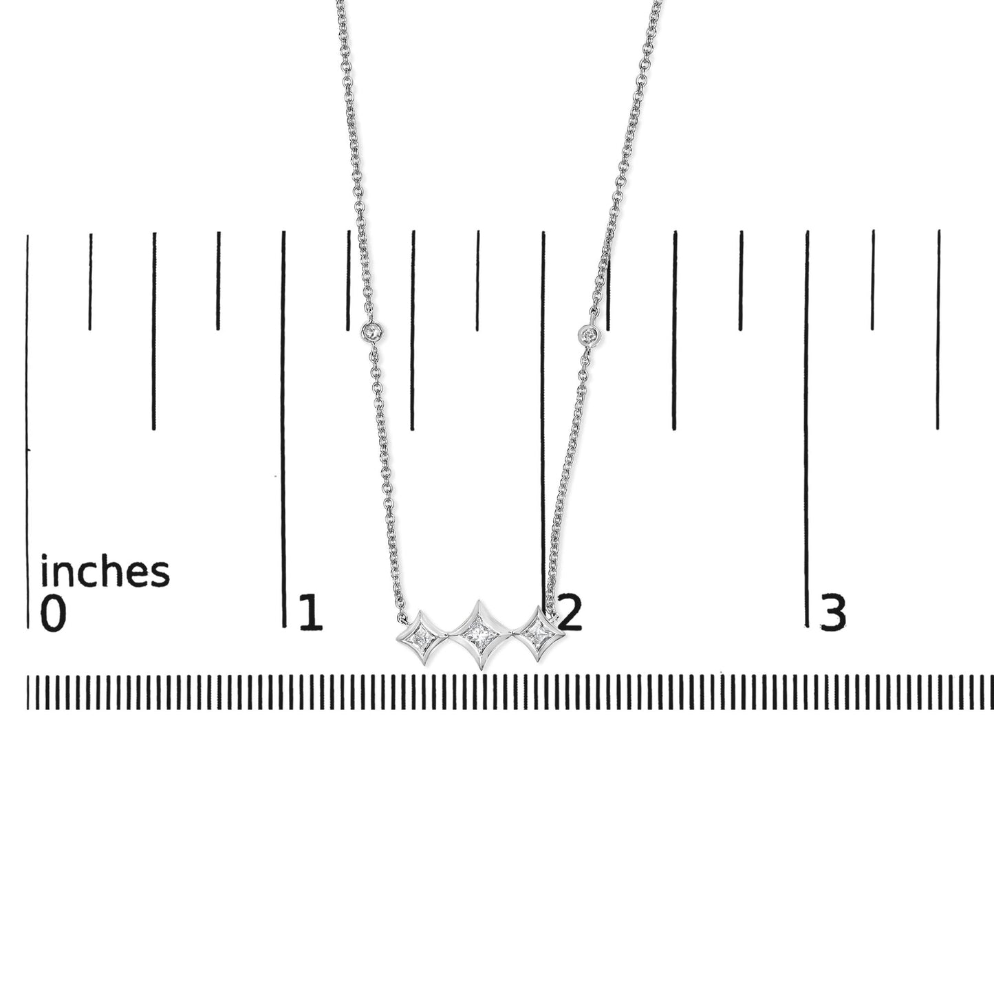 Silver necklace with star-shaped pendant on a white background with measurement scale