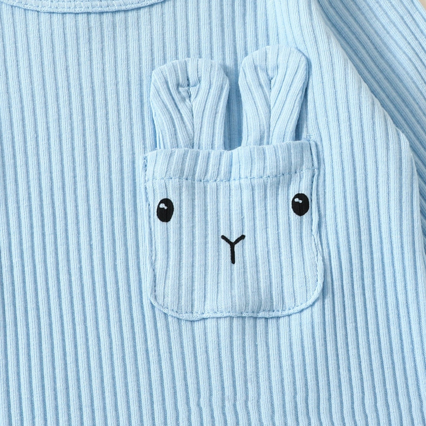 Light blue ribbed fabric with a pocket design resembling a face.