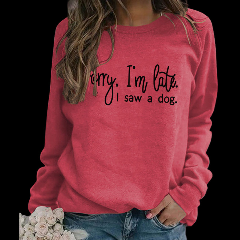 Person wearing a red sweatshirt with text, standing outdoors.