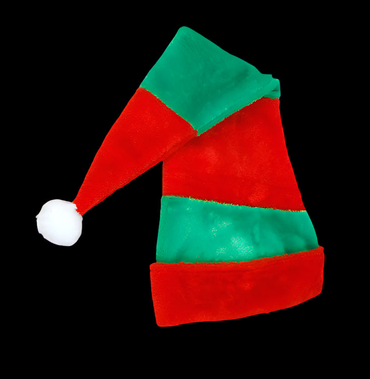 Red and green elf hat with a white pom-pom on a wooden surface
