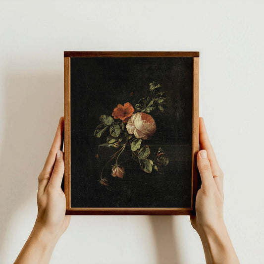 Framed botanical illustration held by hands against a plain background