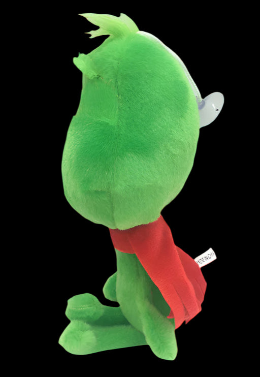 Green plush toy with a red scarf on a white background