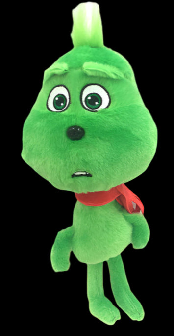 Green plush toy with a red bow tie on a white background