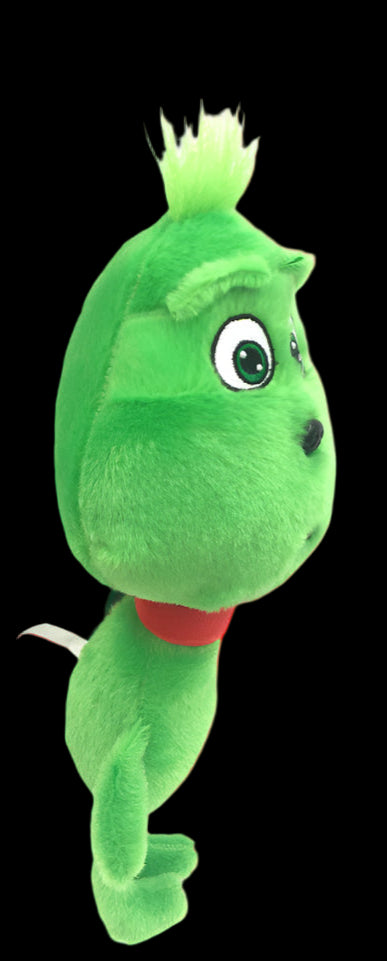 Green plush toy with a red bow tie on a white background