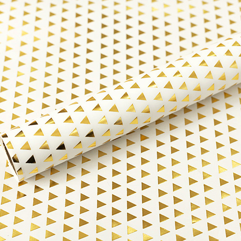 Roll of paper with gold triangle pattern on a white background