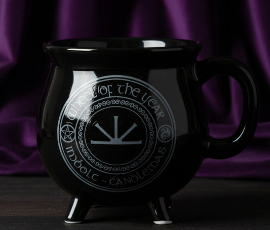 Black mug with a circular design and text on a white background