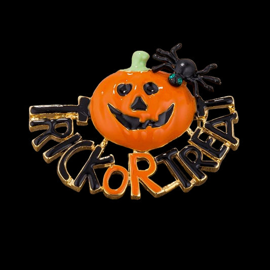 Halloween-themed brooch with pumpkin face, spider, and 'Trick or Treat' text on a wooden background