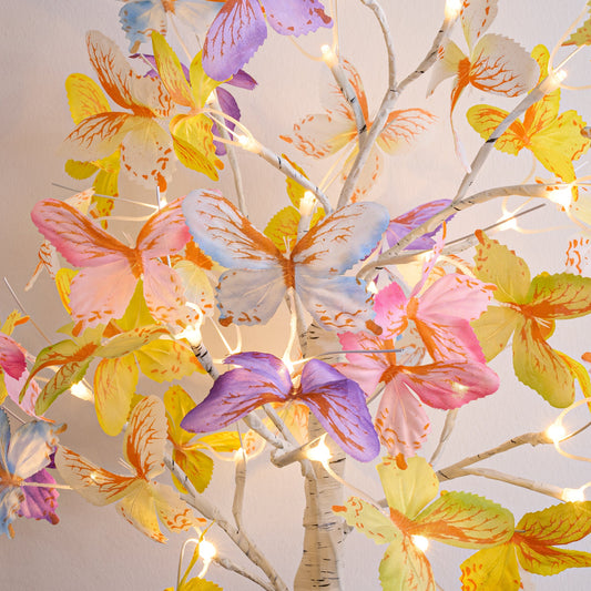 Colorful butterfly and leaf chandelier with lights on a white background