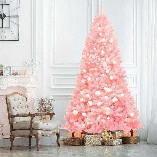 Pink Christmas tree decorated with lights and presents in a room with a chair and decorative items.