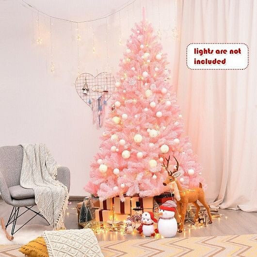 Pink Christmas tree decorated with lights in a room with a gray chair and festive decorations.
