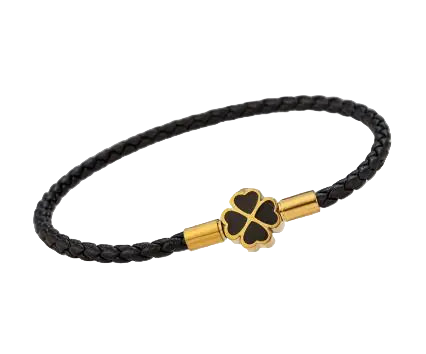 Black braided bracelet with a gold and black clover-shaped clasp on a light gray background