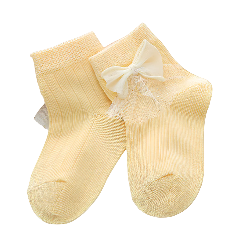 Pair of yellow socks with a bow on a light background