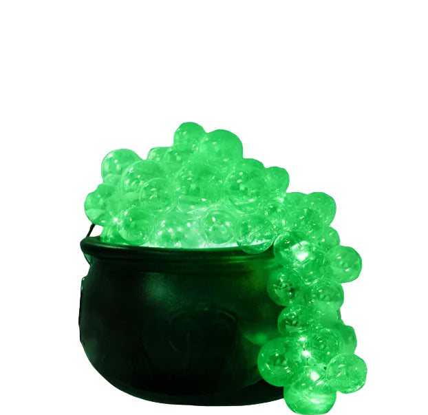 Halloween-themed decor with a glowing green cauldron and festive lights.