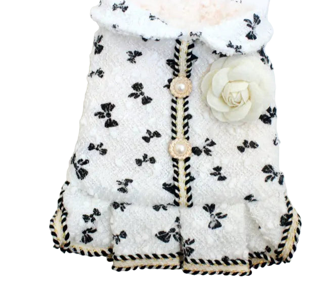 White baby outfit with black floral pattern on a white background