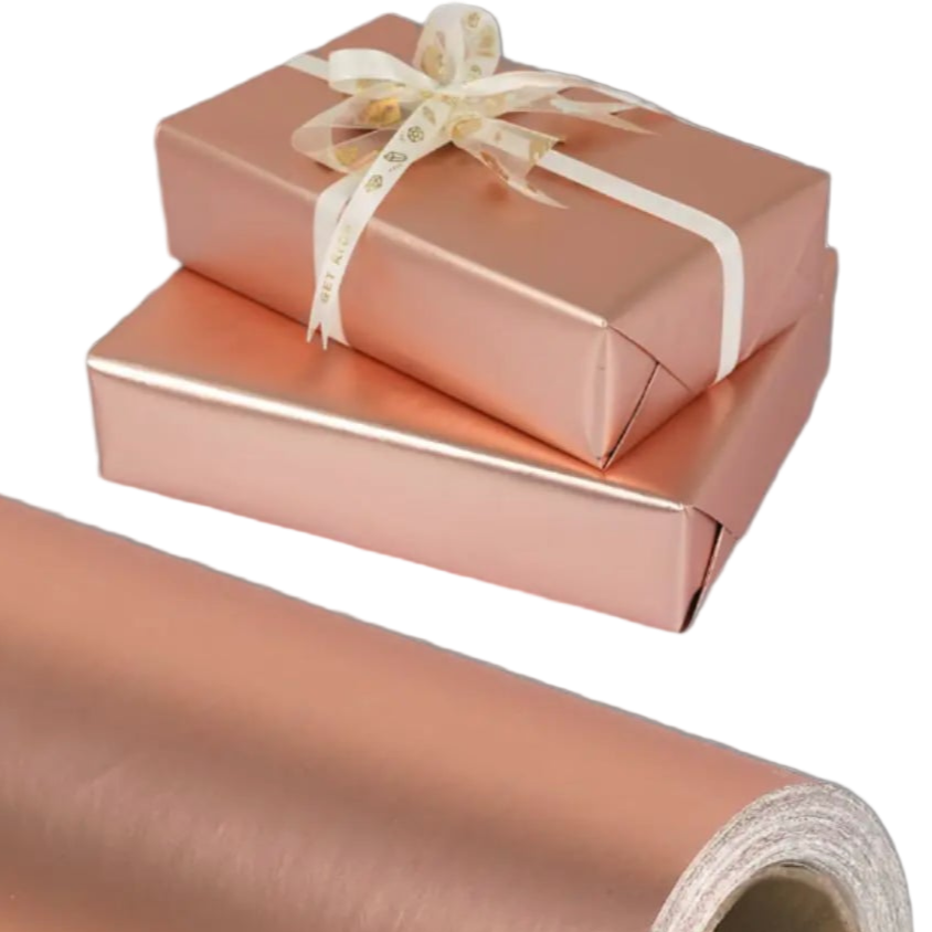 Roll of rose gold gift wrap with two wrapped gifts on a white background