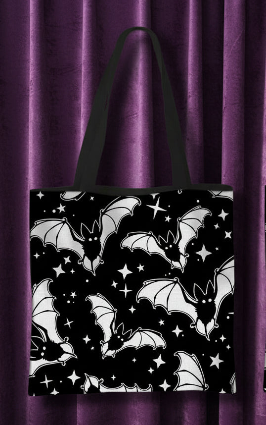 Front and back views of a black tote bag with a white bat and star pattern, shown on a plain white background with red text labels 'front' and 'back'.