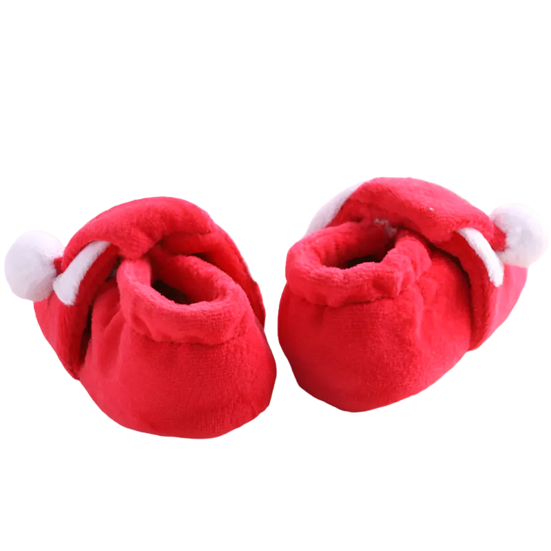 Red baby shoes with white accents on a textured surface