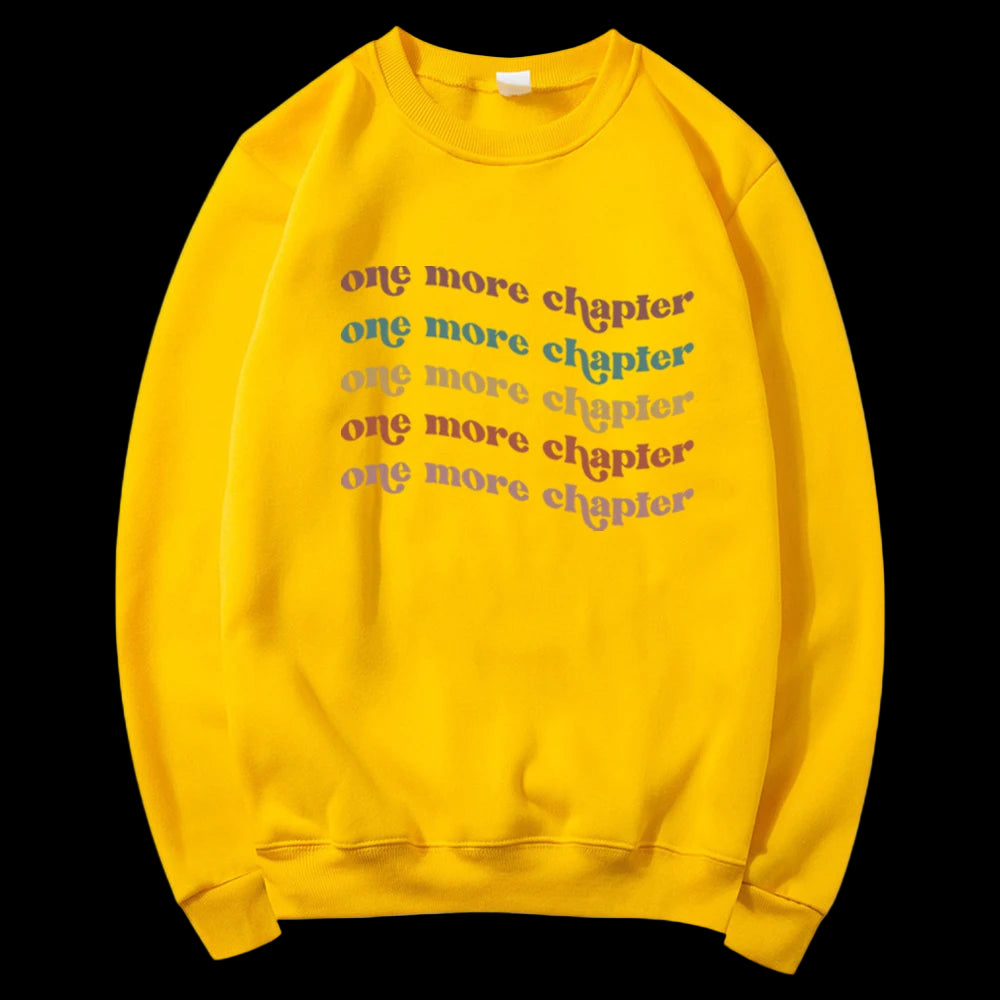 Yellow sweatshirt with 'one more chapter' text in multiple colors on a white background
