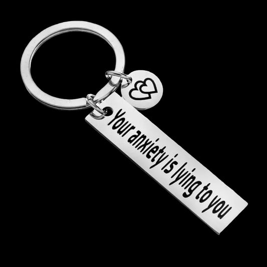 Keychain with motivational message 'Your anxiety is lying to you' on a white background