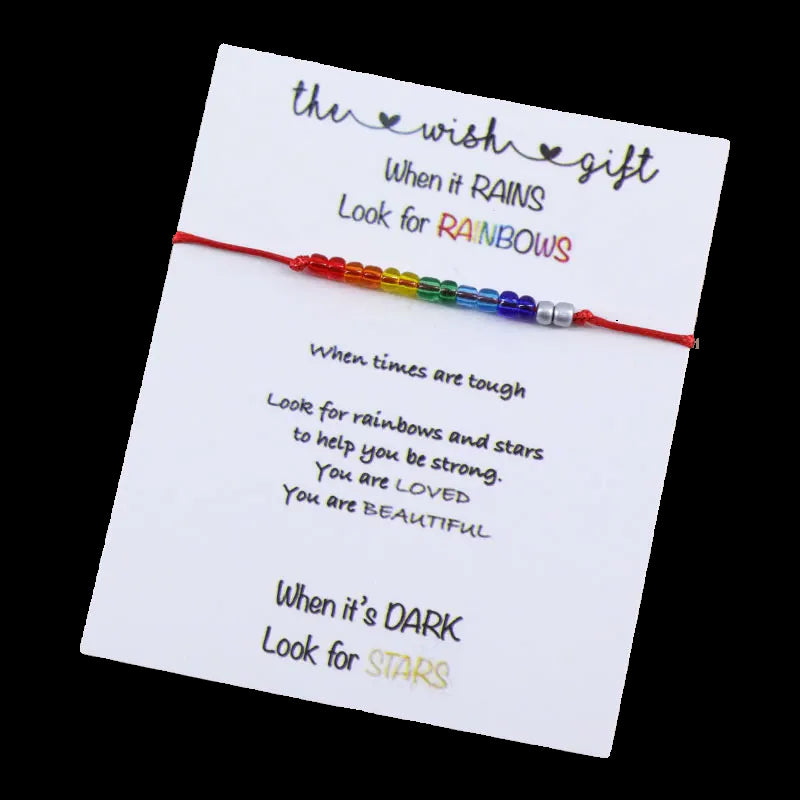 Colorful bracelet on a card with motivational text on a wooden surface