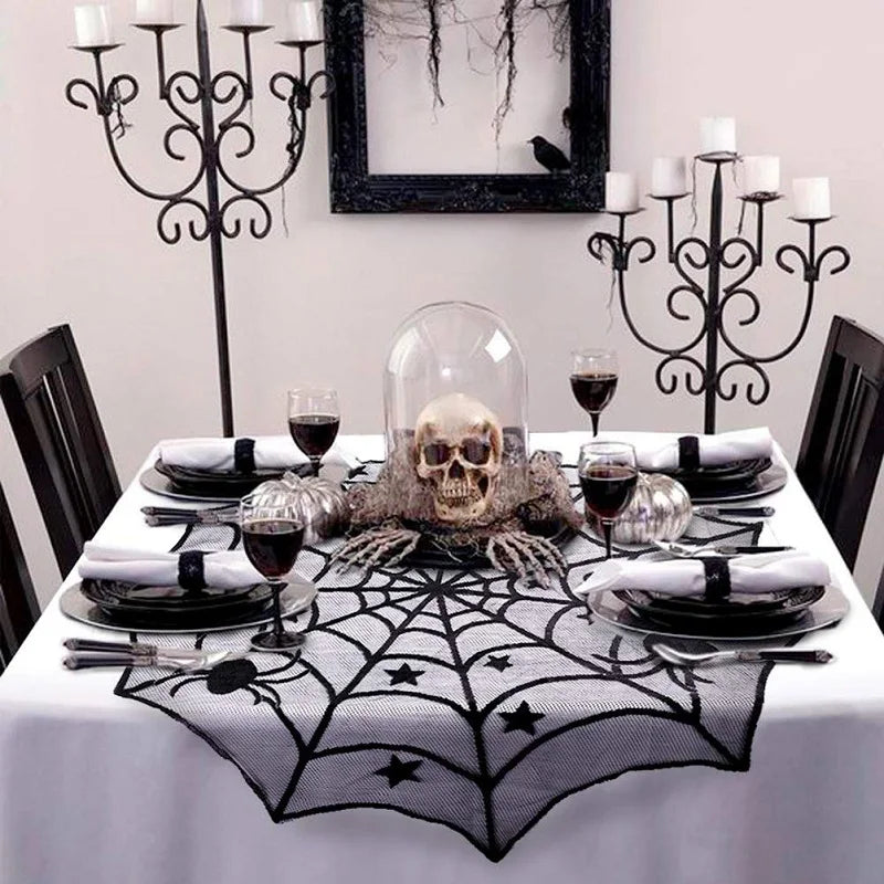 Halloween-themed table setting with skull, spider web, and candelabras.